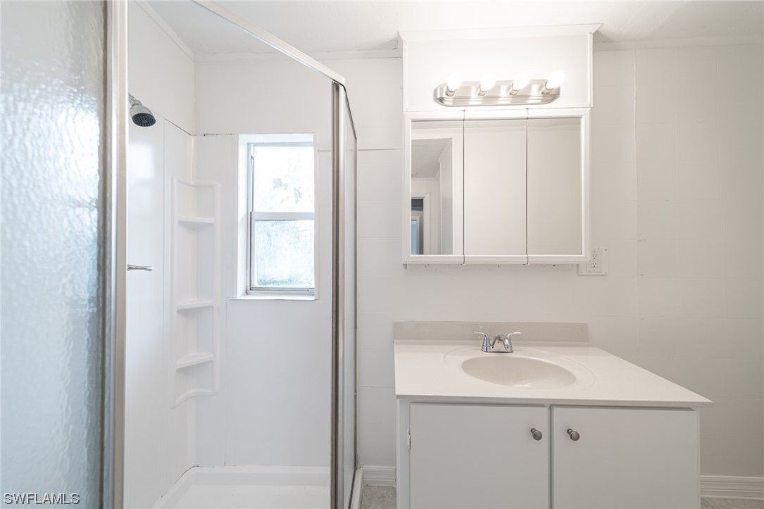 12451 Shawnee Road Fort Myers, FL 33913 - Photo 32 of 39 a bathroom with a sink and a mirror