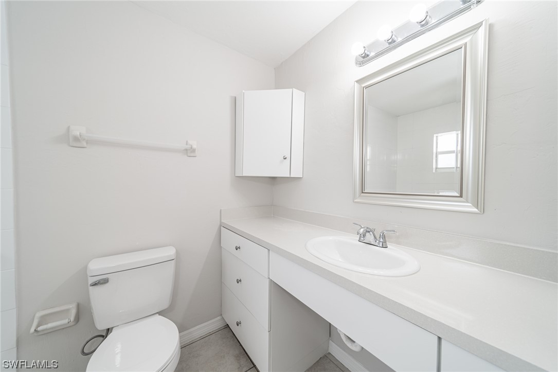 12451 Shawnee Road Fort Myers, FL 33913 - Photo 34 of 39 a bathroom with a toilet sink and mirror