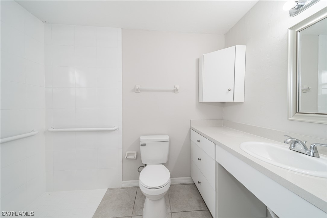 12451 Shawnee Road Fort Myers, FL 33913 - Photo 35 of 39 a bathroom with a granite countertop toilet and sink