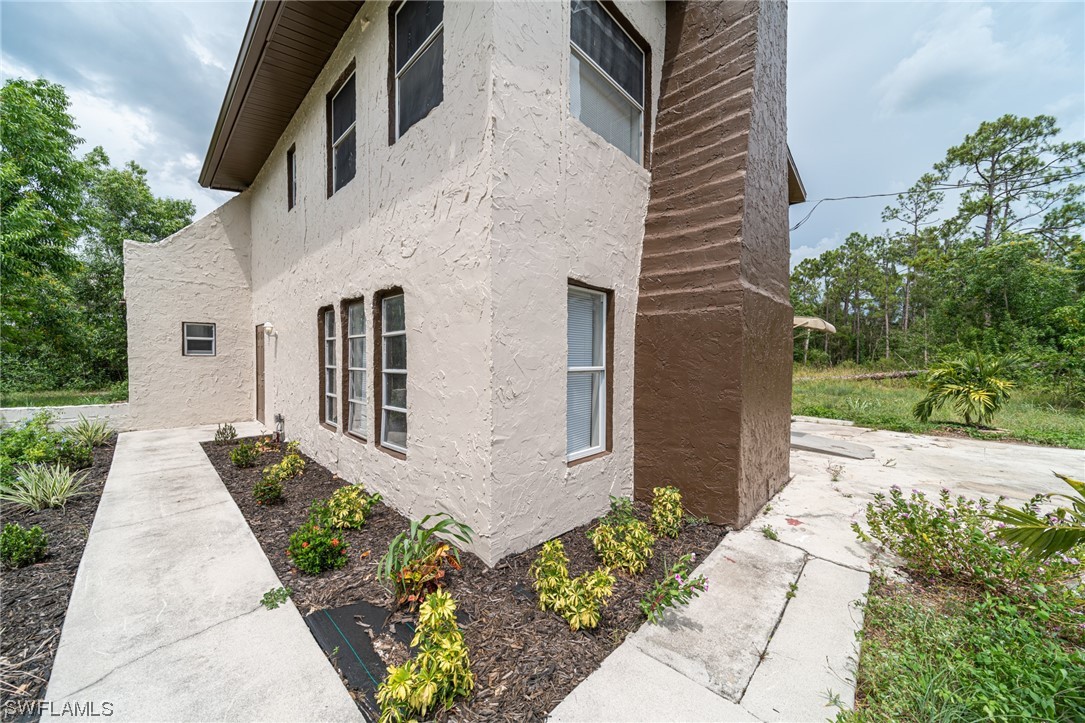 12451 Shawnee Road Fort Myers, FL 33913 - Photo 5 of 39 a front view of a house with garden