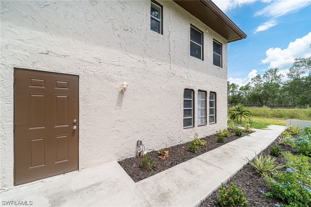 12451 Shawnee Road Fort Myers, FL 33913 - Photo 7 of 39 a front view of a house with garden