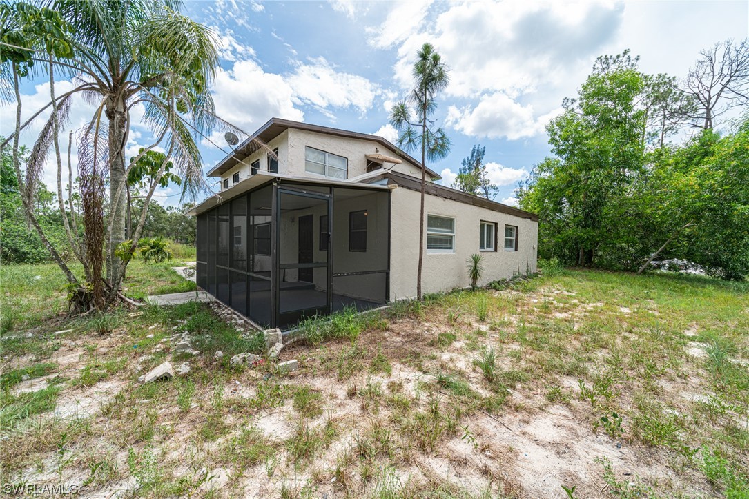12451 Shawnee Road Fort Myers, FL 33913 - Photo 10 of 39 a house with trees in front of it