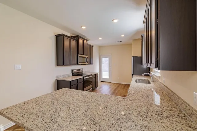 a spacious bedroom with a large bed and a dresser