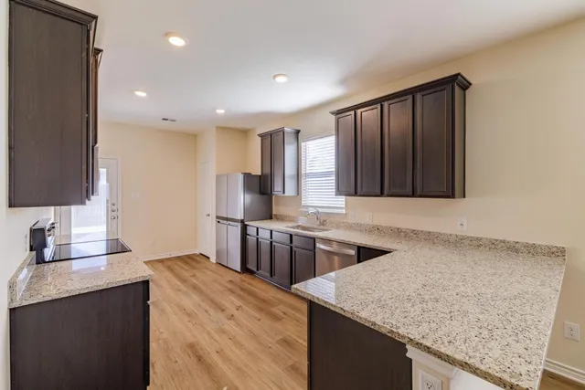a kitchen with stainless steel appliances granite countertop granite counter tops and a stove