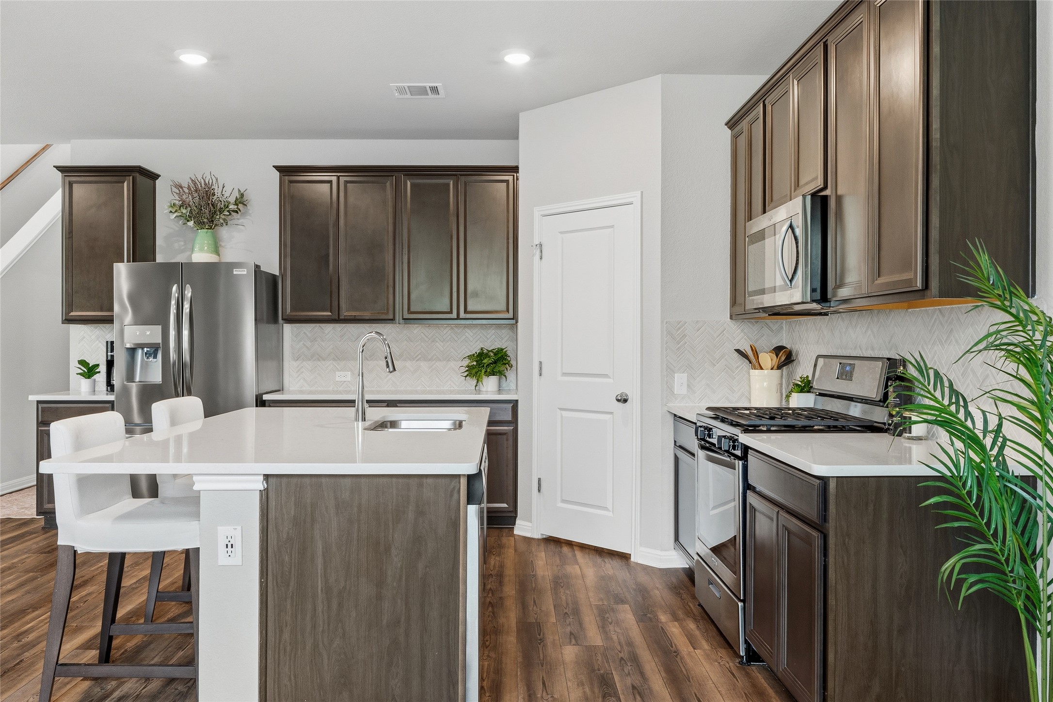 145 Beach Mountain Road Dripping Springs, TX 78620 - Photo 8 of 40 The kitchen is adorned with rich espresso cabinetry.