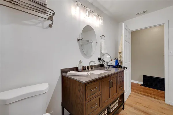 a bathroom with a toilet sink and mirror