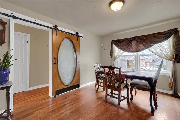 a view of a dining room with furniture and wooden floor