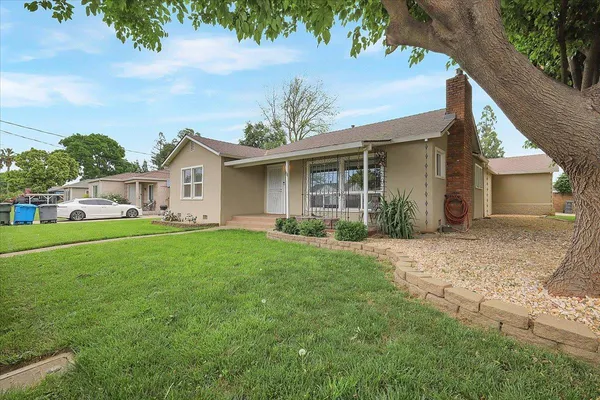 a view of a house with yard and a garden