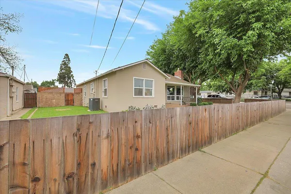 a view of a house with wooden fence