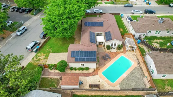 an aerial view of a house with a garden and plants