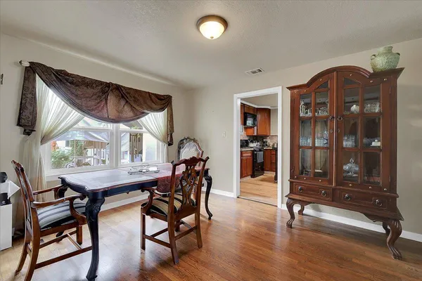 a view of a dining room with furniture and window