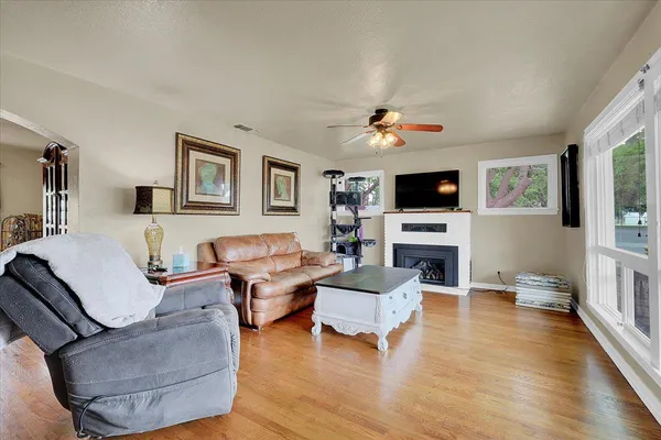 a living room with fireplace furniture and a flat screen tv