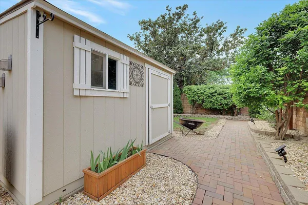 a view of a house with backyard and sitting area