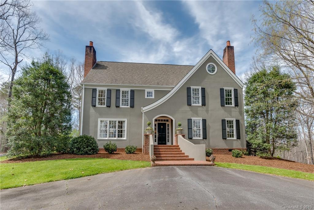 834 New Hope Road Rutherfordton, NC 28139 - Photo 1 of 35 a front view of a house with a garden and plants