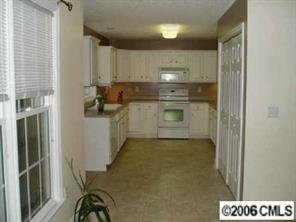3613 Old Camden Road Monroe, NC 28110 - Photo 2 of 8 a kitchen with a refrigerator and a stove