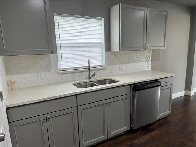 a kitchen with a sink cabinets and window