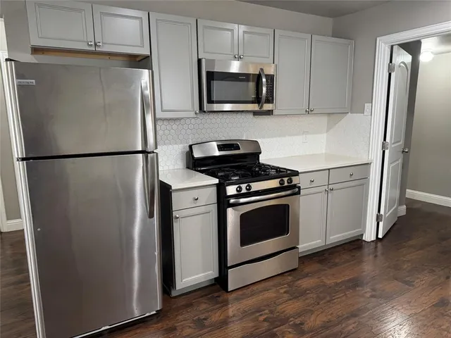 a white refrigerator freezer sitting in a kitchen