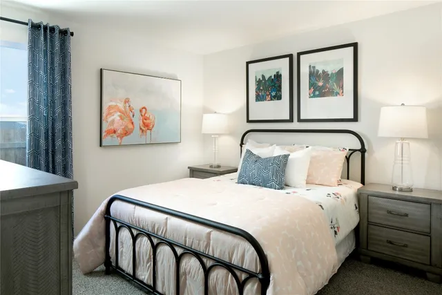 a bedroom with a bed and a painting on the wall