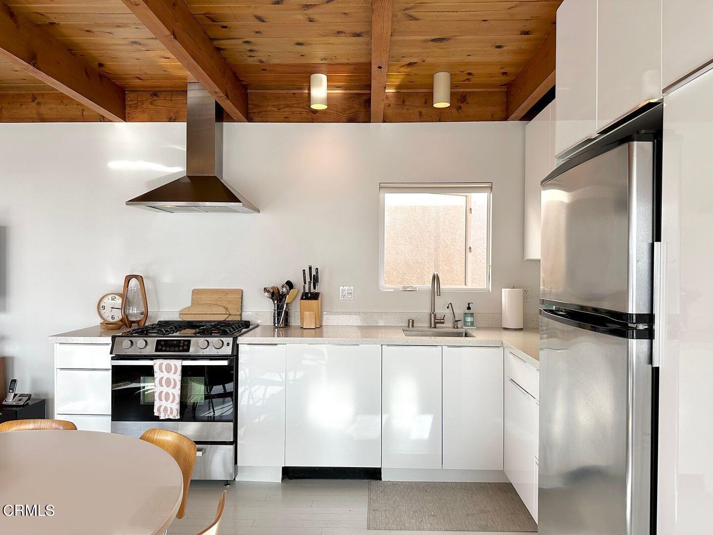 3600 Ocean Drive Oxnard, CA 93035 - Photo 11 of 36 a kitchen with stainless steel appliances a sink and a refrigerator