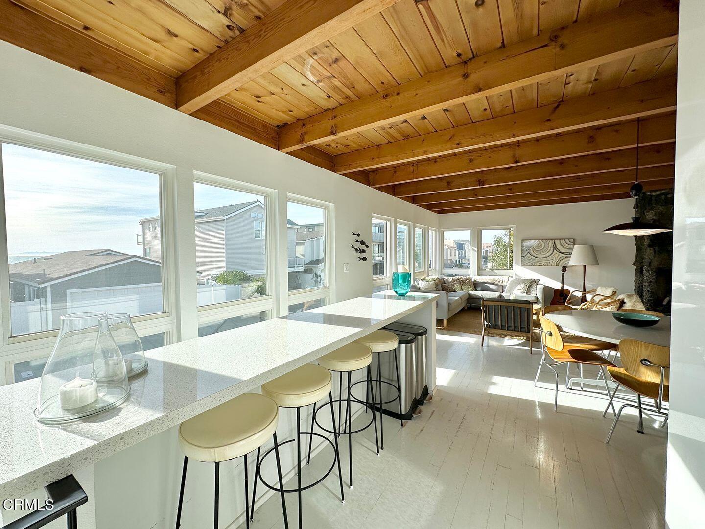 3600 Ocean Drive Oxnard, CA 93035 - Photo 14 of 36 a room with lots of wooden furniture and a large window