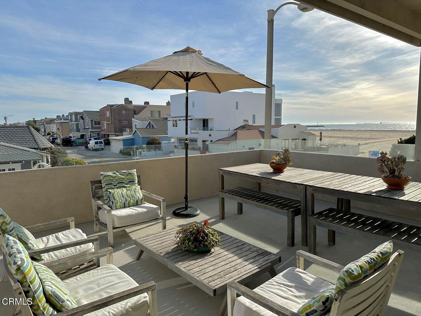 3600 Ocean Drive Oxnard, CA 93035 - Photo 16 of 36 a view of a terrace with furniture and umbrella