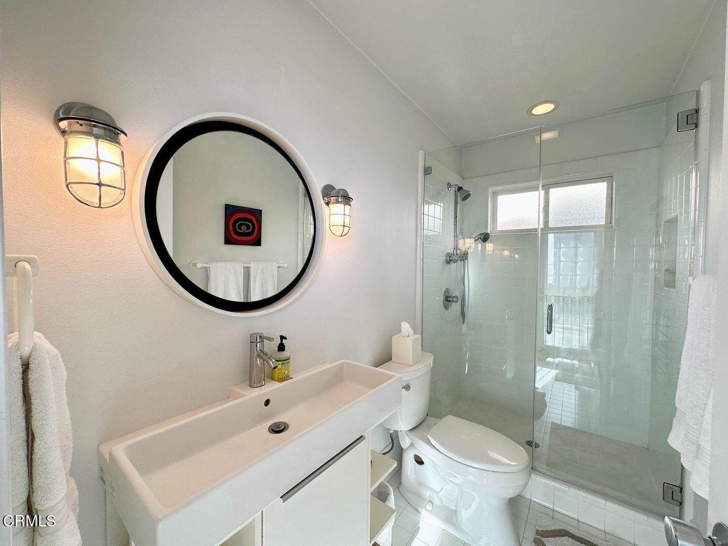 3600 Ocean Drive Oxnard, CA 93035 - Photo 21 of 36 a bathroom with a toilet a sink and a mirror
