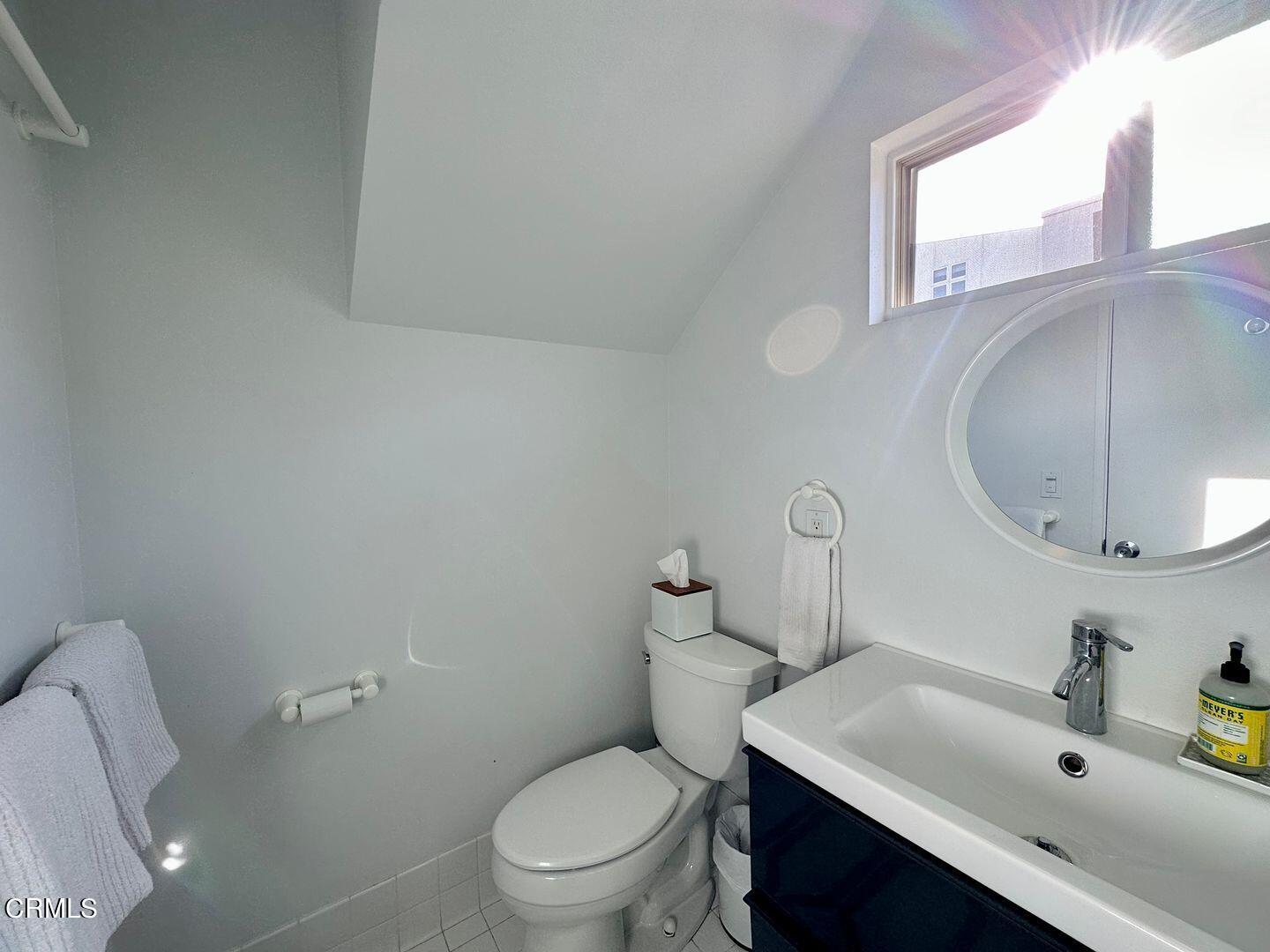 3600 Ocean Drive Oxnard, CA 93035 - Photo 24 of 36 a bathroom with a toilet a sink a vanity and mirror