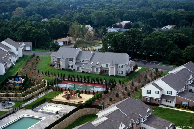 an aerial view of a house with yard swimming pool and outdoor seating
