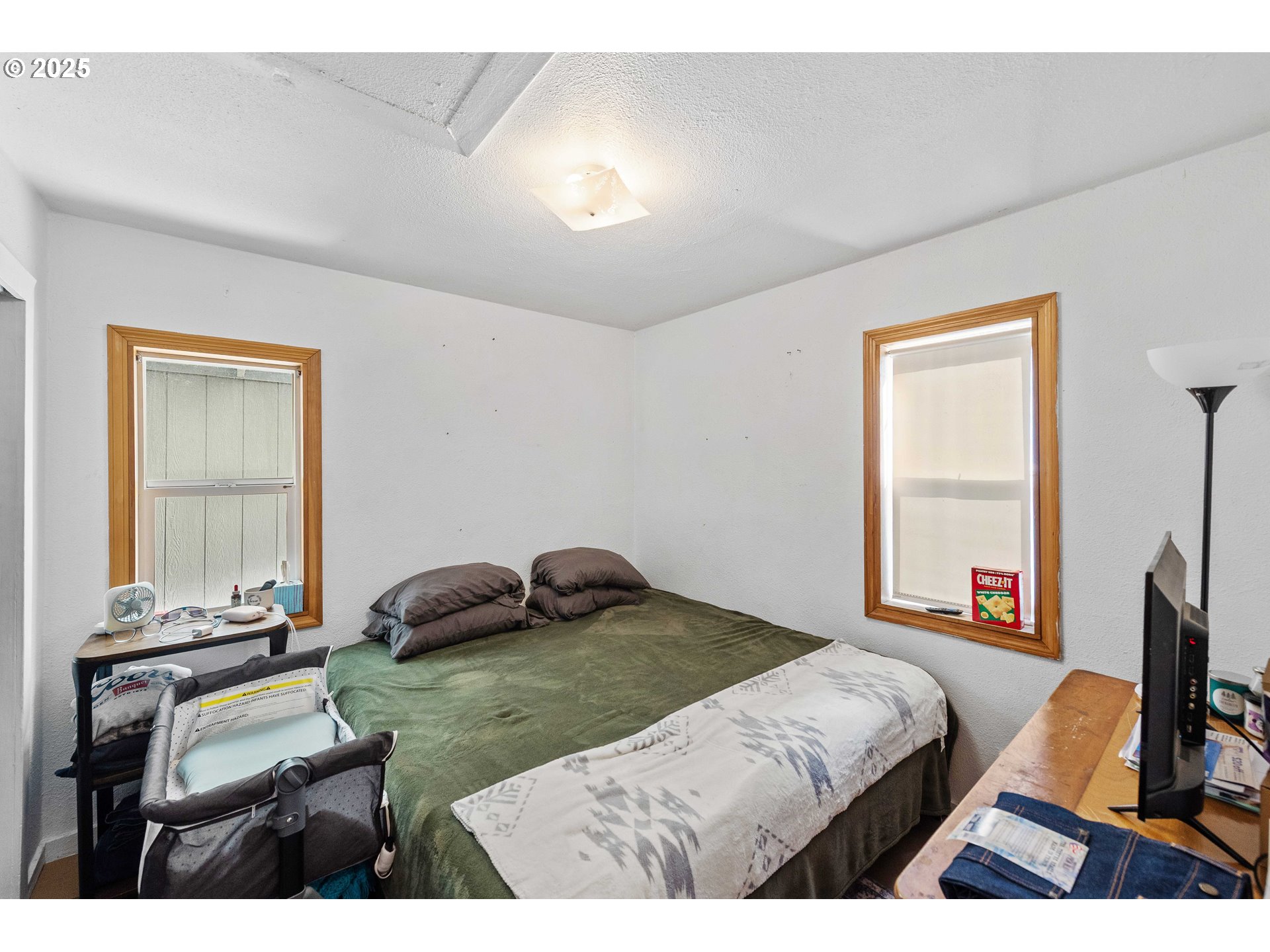 805 C Street Myrtle Point, OR 97458 - Photo 7 of 30 a bedroom with a bed a table and chair