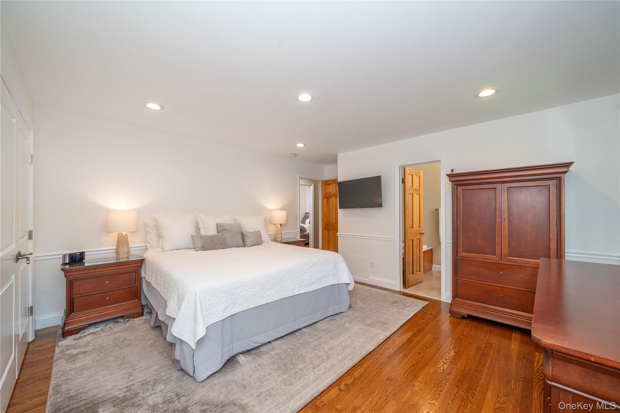 53 Tarryhill Road Tarrytown, NY 10591 - Photo 17 of 35 Generously sized primary bedroom with hardwood floors and an en-suite bath.
