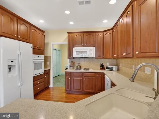 a kitchen with stainless steel appliances granite countertop a refrigerator sink and cabinets