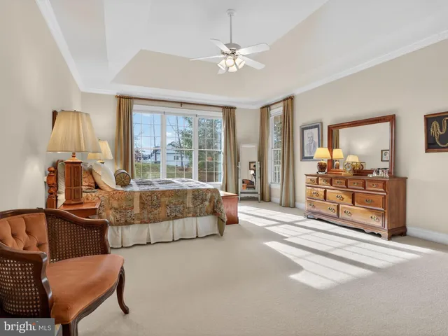 a bedroom with a bed couch and window