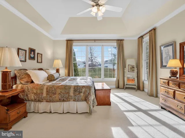 a bedroom with a large bed and a chandelier