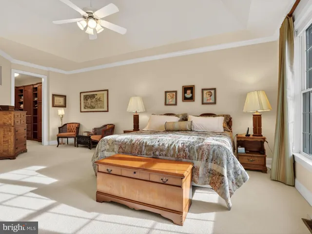 a spacious bedroom with a bed and furniture