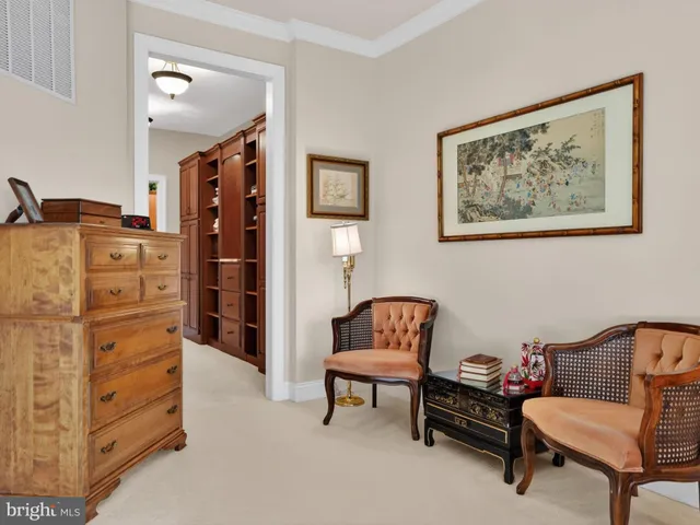 a bedroom with furniture and a lamp