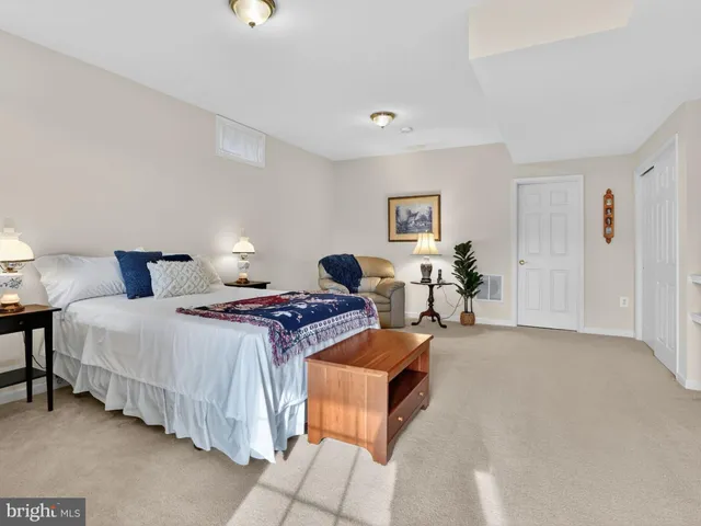 a bedroom with bed and a lamp with window