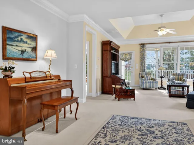 a living room with furniture and large windows