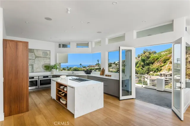 a kitchen with stainless steel appliances a stove a sink and a refrigerator