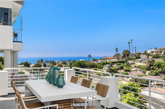 a view of a balcony with table and chairs