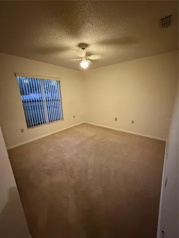 a view of an empty room with a chandelier
