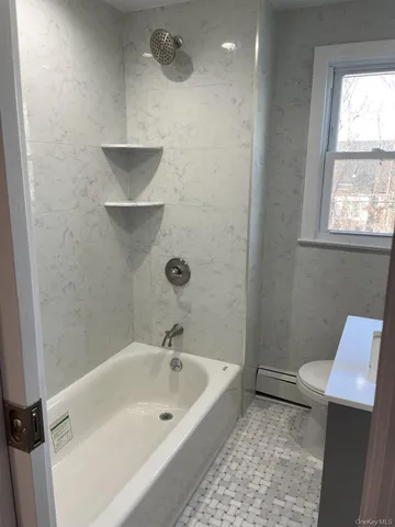 a bathroom with a bathtub and a sink