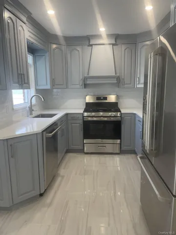 a kitchen with a stove sink and refrigerator