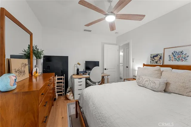 a bedroom with a bed and wooden floor