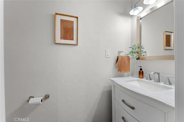 a bathroom with a sink vanity and a mirror