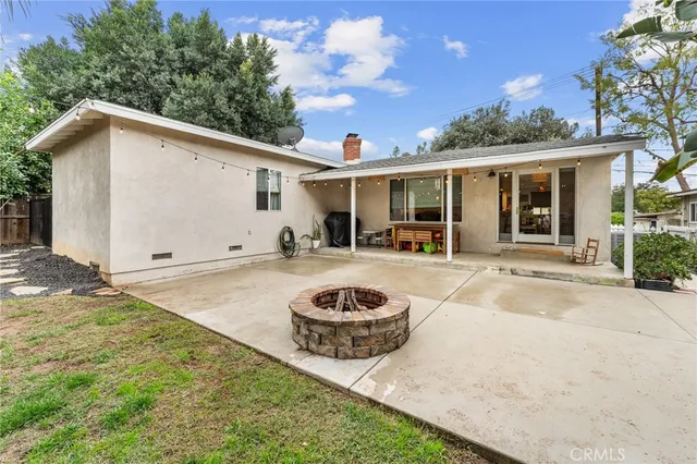 a backyard of a house with yard barbeque oven and outdoor seating