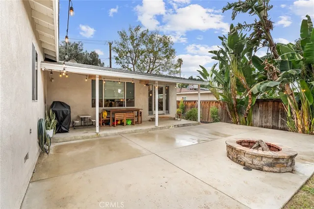 a view of a house with wooden fence