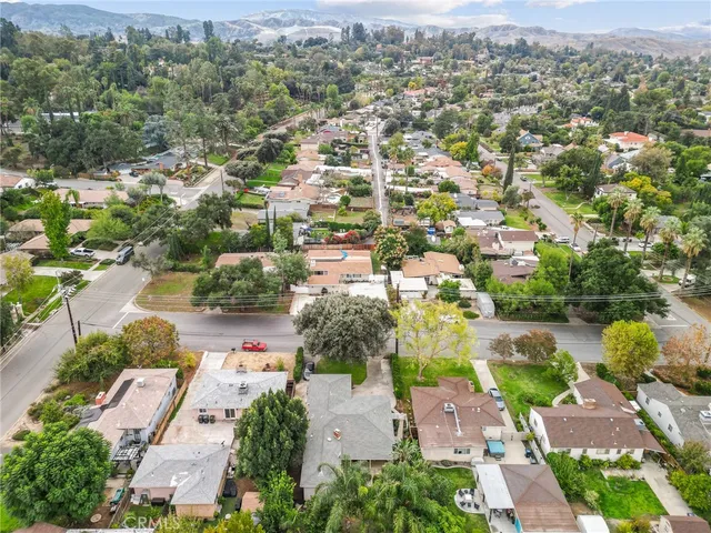 an aerial view of residential houses with outdoor space and street view