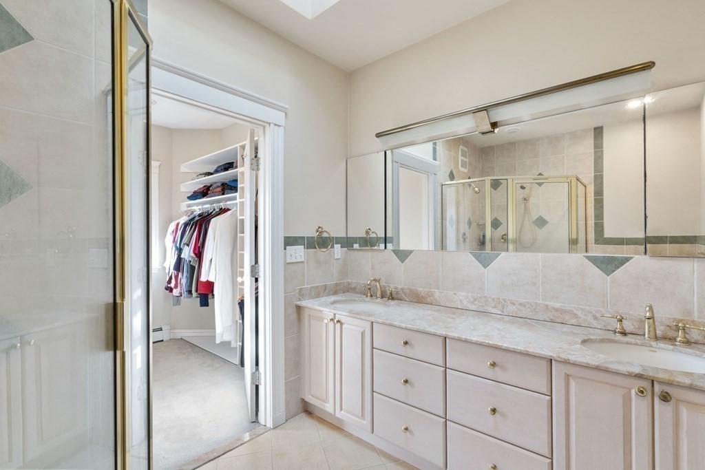 27 Nobscot Road Newton, MA 02459 - Photo 11 of 25 a en suite bathroom with a granite countertop sink and a mirror