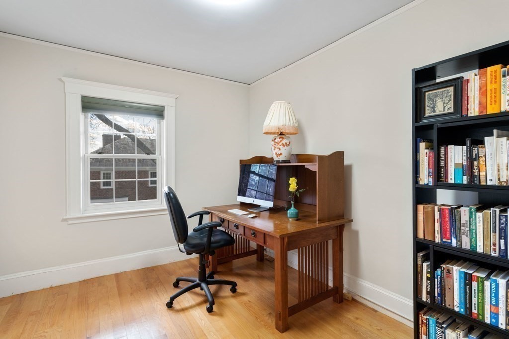 27 Nobscot Road Newton, MA 02459 - Photo 14 of 25 a view of a workspace with bookshelf and a window