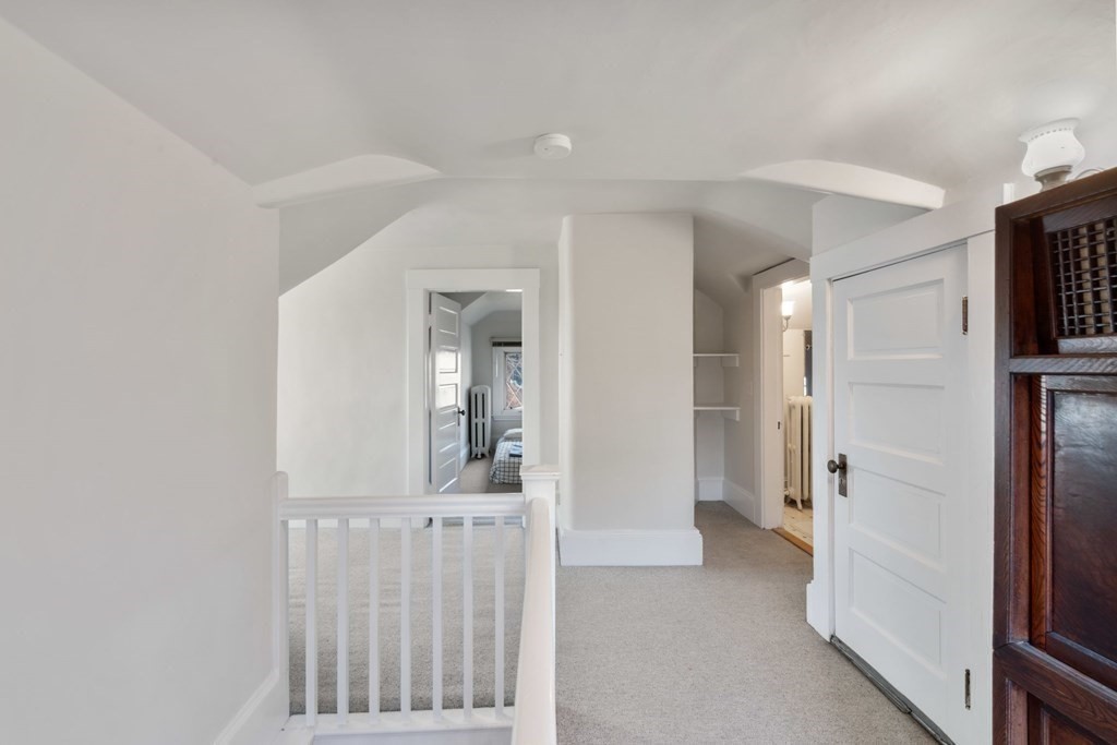 27 Nobscot Road Newton, MA 02459 - Photo 16 of 25 a view of a hallway with white walls and stairs